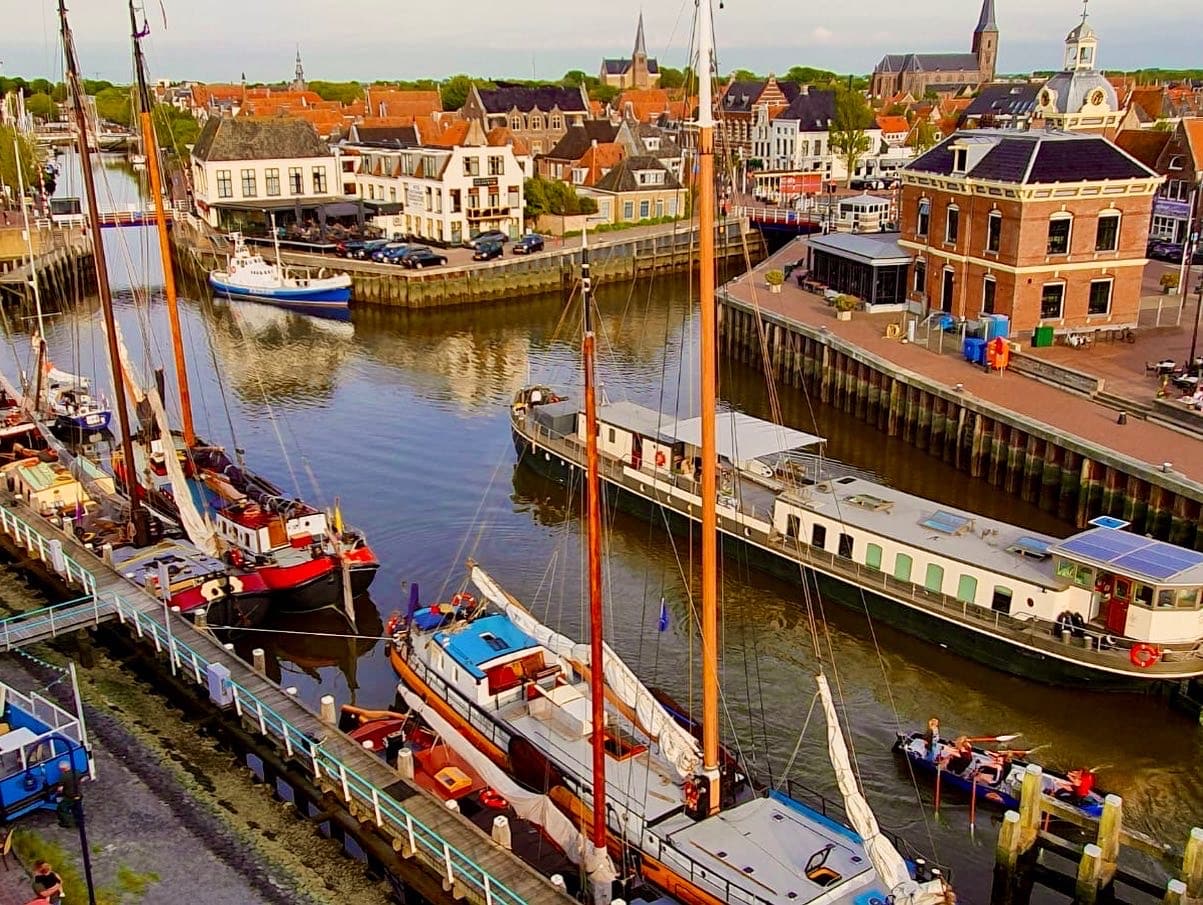 Charming Dutch waterside town with canal, boats, and traditional houses